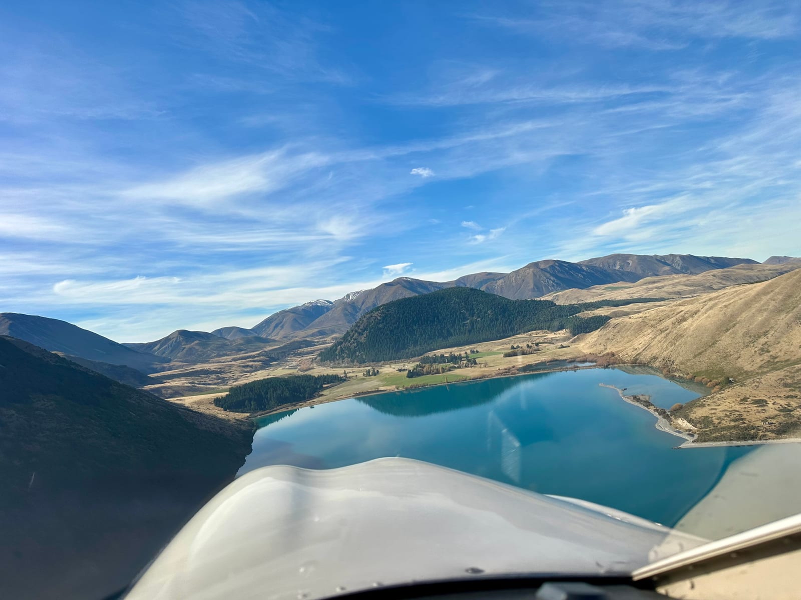 View from a light aircraft flying over a New Zealand mountain lake.